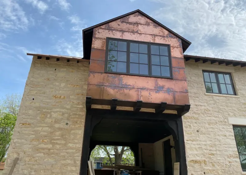 Copper metal panel facade on a stone building for Metal Roof Coating in Warren